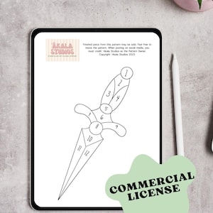 May include: A digital tablet displays a black and white line drawing of a dagger with numbered sections, labeled 1-12. The image includes the text "AKALA STUDIOS" and "COMMERCIAL LICENSE". A stylus and a small potted plant are visible.