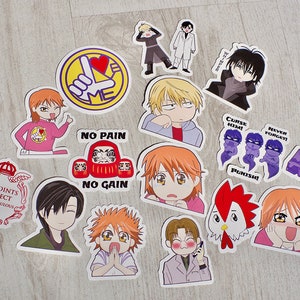 Peut inclure: Une collection d'autocollants de style anime colorés mettant en scène des personnages avec différentes expressions et poses. Certains autocollants ont du texte, notamment "No Pain No Gain", "Curse Him!" et "Never Forget!"