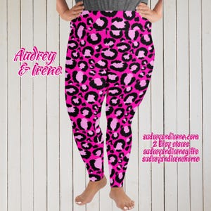 May include: Pink and black leopard print leggings. The leggings have a high waist and a bold pattern. The text "Audrey & Irene" is on the left side, and website information is on the right side.