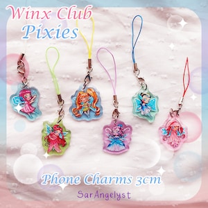 May include: A collection of seven colorful phone charms featuring Winx Club Pixies. Each charm is approximately 3cm and depicts a different fairy character with vibrant wings and outfits. The charms have a clear, glossy finish and are attached to colored lanyards.