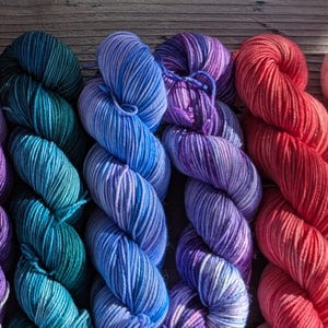 Dragon Thistle sets, worsted weight,  various color combinations of 2 or 3 skeins. Each skein is 50g and sw merino