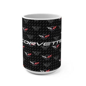 May include: White ceramic mug featuring a repeating pattern of the Corvette logo in red, black, and white. The word "CORVETTE" is printed in white across the mug's center, set against a black textured background.