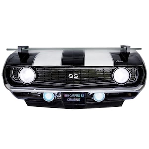 May include: Black and white 1969 Camaro SS with a glass shelf, the car has a black grille and the text "1969 CAMARO SS CRUISING" on the license plate.