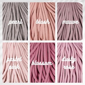 May include: A collection of six different colored macrame cords. The colors include pearl, blush, mauve, pastel pink, blossom, and dusty rose. Each color is labeled with a white cursive font.