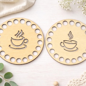 May include: Two round wooden bases with a coffee cup design. Each base has a series of evenly spaced holes around the perimeter. The coffee cup is etched into the wood, with steam rising from the cup.