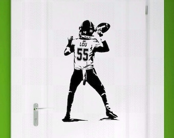 May include: Black and white silhouette of a football player throwing a football. The player is wearing a jersey with the number 55 and the name "LOU" on the back.