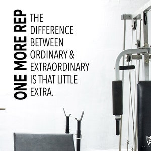 May include: Black and white motivational quote on a white wall: "One more rep. The difference between ordinary & extraordinary is that little extra."
