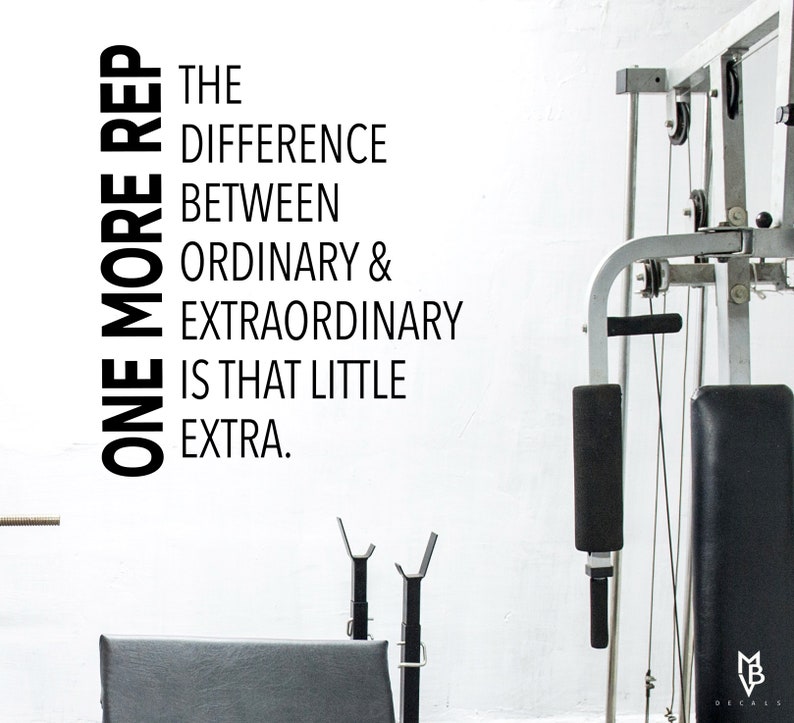 May include: Black and white motivational quote on a white wall: "One more rep. The difference between ordinary & extraordinary is that little extra."