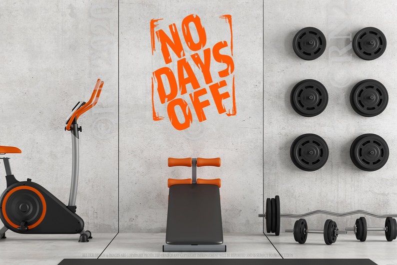 May include: A home gym with an exercise bike, a weight bench, and weights. The wall has a motivational quote that says "NO DAYS OFF" in orange.