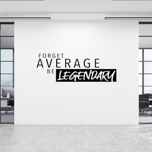 May include: Black and white motivational quote on a white wall in an office setting. The quote reads "Forget Average Be Legendary".