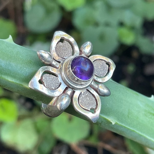 Jolie bague en Argent massif en forme  de fleur ornée au centre par une améthiste