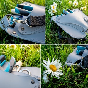 May include: A gray leather gardening tool belt with a black strap and multiple pockets. The belt is filled with gardening tools, including shears, a trowel, and a pruning saw.