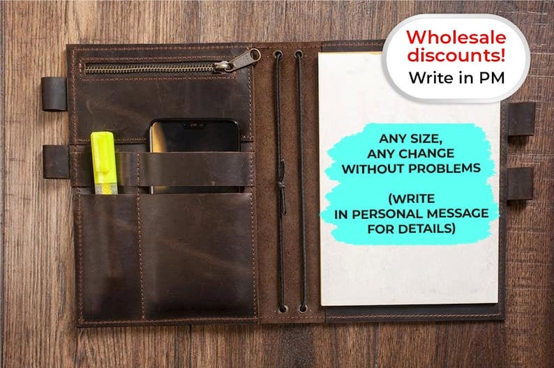 May include: A brown leather notebook with a zippered pocket, a pen holder, and a phone pocket. The notebook has a white page open and a blue note on the page that says "ANY SIZE, ANY CHANGE WITHOUT PROBLEMS (WRITE IN PERSONAL MESSAGE FOR DETAILS)". The notebook is on a wooden surface. Wholesale discounts! Write in PM.