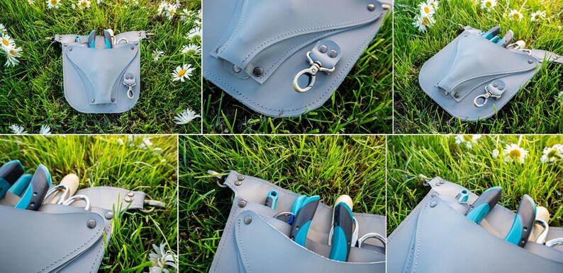 May include: A gray leather gardening tool belt with multiple pockets and a metal clip. The belt is lying on a bed of green grass with white flowers.
