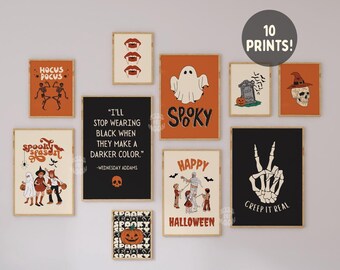 May include: A collection of ten framed Halloween-themed prints. The prints feature various designs, including skeletons, ghosts, pumpkins, and text like "Spooky Season" and "Creep it Real." The color palette includes orange, black, and cream.