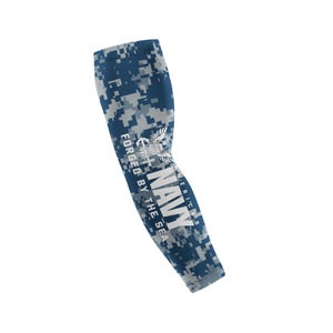 May include: Navy blue and gray camouflage arm sleeve with the text "NAVY" and "FORGED BY THE SEA" in white. The sleeve features a digital camouflage pattern and a navy emblem.