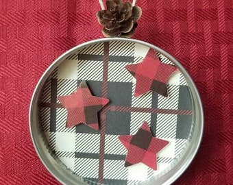 Mason Jar Lid Holiday Ornament with Red Plaid Stars on Buffalo Plaid Background and Pinecone Accent