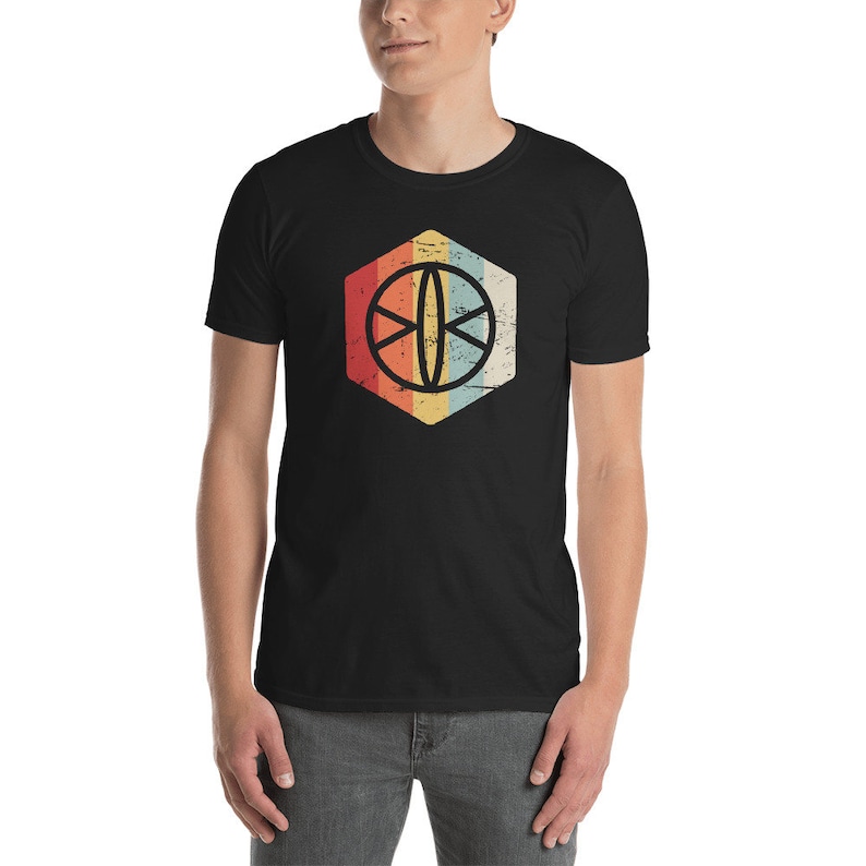 May include: A black t-shirt with a retro-style graphic of a basketball in a hexagon. The hexagon is filled with a gradient of red, orange, yellow, and blue.