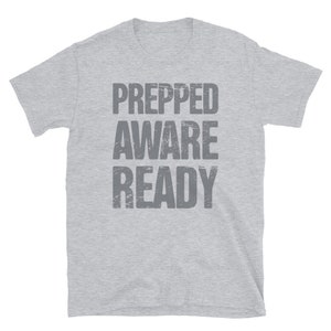 May include: A heather grey t-shirt with the text "PREPPED AWARE READY" printed in a distressed grey font.