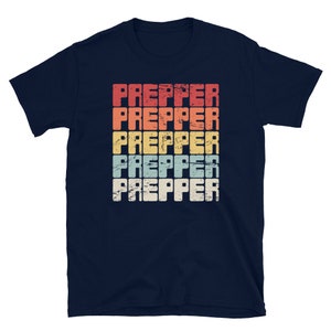 May include: Navy blue t-shirt with a vintage-style graphic of the word "PREPPER" repeated five times in different colours.