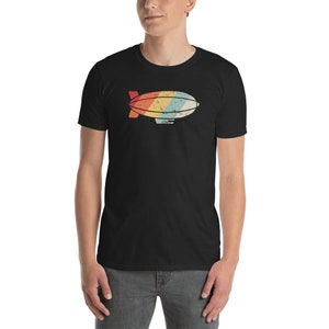 May include: A black t-shirt with a retro-style graphic of a blimp in rainbow colors.