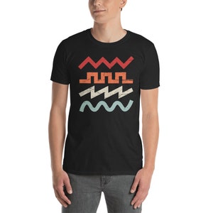 May include: A black t-shirt with a retro-style graphic of four different wavy lines in red, orange, yellow, and blue.