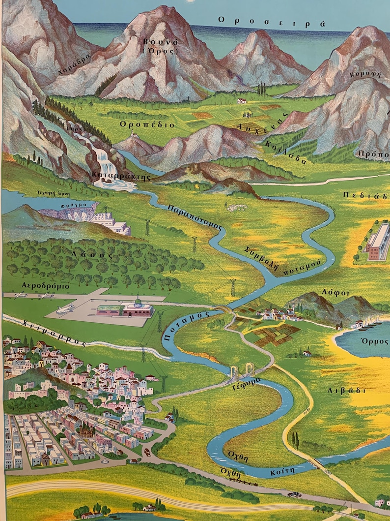 May include: A vintage illustrated map depicting a landscape with mountains, a river, and various geographical features. The map includes labels in Greek, showcasing a detailed view of the terrain, including a town, airport, and bridge.