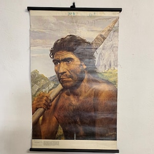 May include: Vintage educational poster showing a Neanderthal man carrying a spear, with a mountain and sky background. The poster is mounted on a black rod and is likely from the 1970s.