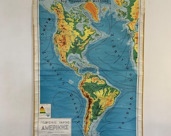 May include: A vintage, blue and green physical map of North and South America. The map shows the continents' topography, with different shades of green and brown representing elevation. The map also includes the names of major oceans and seas, as well as the text "ΓΕΩΦΥΣΙΚΟΣ ΧΑΡΤΗΣ ΑΜΕΡΙΚΗΣ" (Greek for "Physical Map of America").