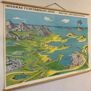 May include: Vintage educational map of a geographical region, featuring mountains, rivers, and coastal areas. The map is in a colorful, illustrated style, with text in Greek. It is mounted on wooden rods for hanging.