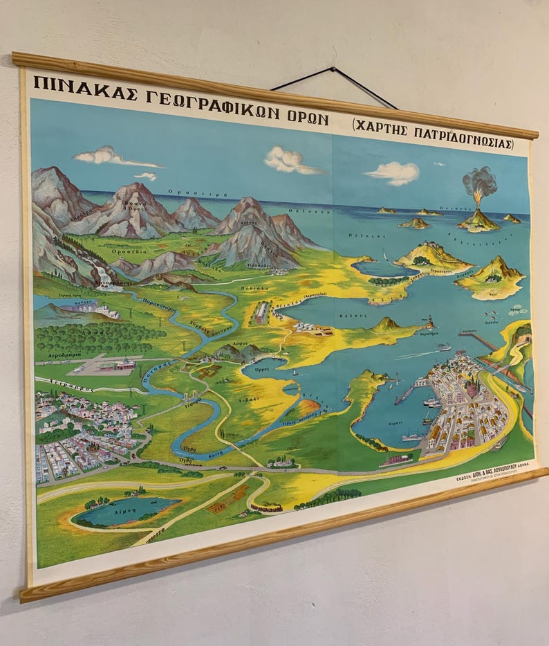May include: Vintage educational map of a geographical region, featuring mountains, rivers, and coastal areas. The map is in a colorful, illustrated style, with text in Greek. It is mounted on wooden rods for hanging.