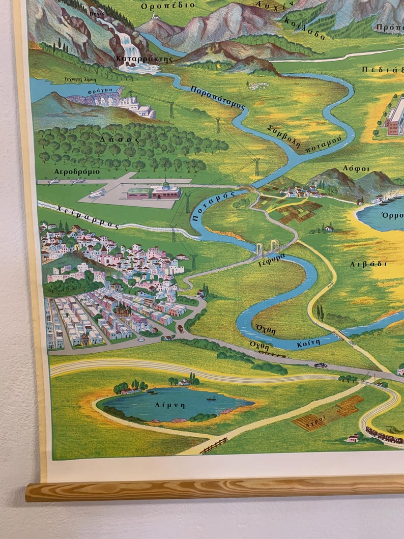 May include: A vintage, illustrated map featuring a river winding through a valley, with mountains in the background. The map includes labels in Greek, depicting a town, lake, and airport. The color palette is dominated by greens, blues, and yellows.