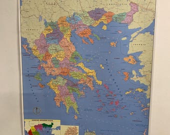 May include: A colorful political map of Greece, with the Greek words "ΕΛΛΑΔΑ ΠΟΛΙΤΙΚΟΣ" at the top. The map shows the country's regions in various colors, with a blue sea and a smaller map in the lower left corner.