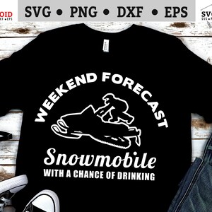 May include: Black t-shirt with white text that reads "Weekend Forecast Snowmobile with a chance of drinking". A white silhouette of a person riding a snowmobile is above the text.