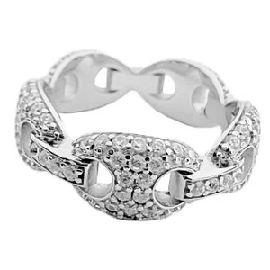 May include: A silver-toned ring with a chain-link design. The ring is encrusted with small, clear gemstones, creating a sparkling effect. The links are shaped like elongated ovals with a central bar.