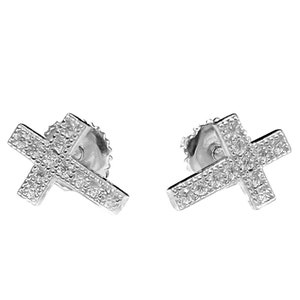 May include: A pair of silver cross earrings with small clear stones set into the cross design.