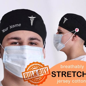 Peut inclure: Un bonnet de travail noir avec un symbole médical blanc et le texte "Your Name" brodé sur le devant. Le bonnet a un bouton rouge sur le côté et un élastique blanc. Le bonnet est fait de coton jersey extensible.