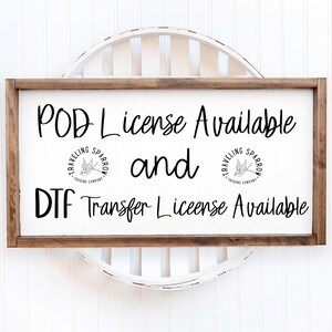 May include: A white sign with brown wood framing, displaying the text "POD License Available and DTF Transfer License Available". The sign features two small black and white logos with the text "Traveling Sparrow Trading Company" and a stylized sparrow.
