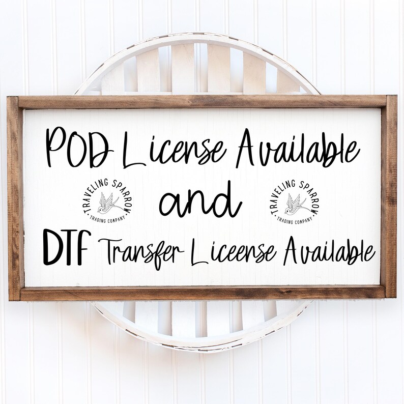 May include: A white sign with brown wood framing, displaying the text "POD License Available and DTF Transfer License Available". The sign features two small black and white logos with the text "Traveling Sparrow Trading Company" and a stylized sparrow.