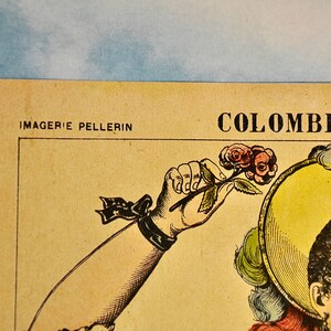 May include: A vintage-style paper print featuring the text IMAGERIE PELLERIN and COLOMBINE. The illustration depicts a figure with dark curly hair wearing a yellow hat with feathers, holding a small stem with pink roses in a raised hand.