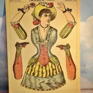 May include: A vintage paper doll sheet titled COLOMBINE (Pantin) featuring a central figure with a yellow hat, blue jacket, and yellow skirt. The sheet includes detached arms and legs with floral accents, printed on cream paper with text.