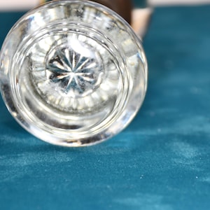 May include: A clear glass doorknob with a starburst pattern on the underside.