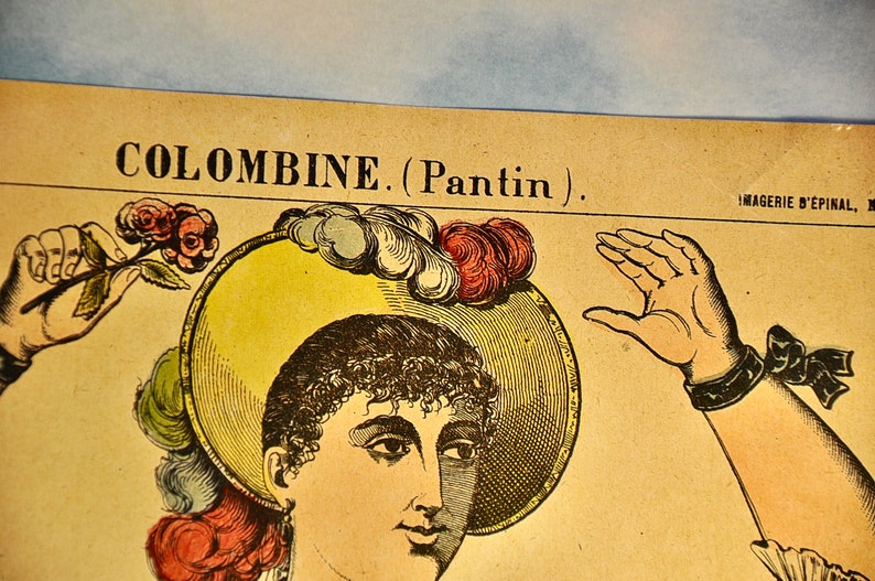 May include: A vintage-style paper print titled COLOMBINE. (Pantin) featuring a detailed illustration of a person wearing a wide-brimmed yellow hat adorned with red and white feathers. The figure holds a small stem with two red roses in one hand.