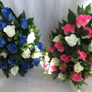 May include: Two bouquets of artificial roses, one with blue roses and white roses, the other with pink roses and white roses.