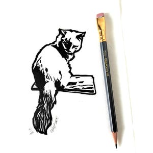 Kitten on Book – Original handmade B&W linocut limited edition print of a beautiful kitten. Printed, signed and numbered by the artist.