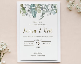 May include: A white wedding invitation with gold lettering. The invitation features a watercolor illustration of eucalyptus leaves and the text "Together with their families Laura & Neil Invite you to celebrate their wedding August 15 at 2 PM 2021 Hilton Hotel Weston Super Mare."