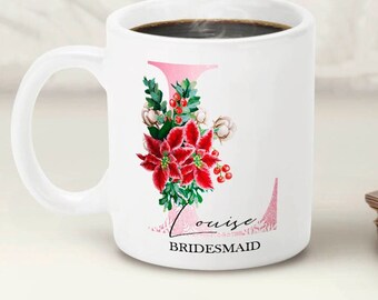 May include: White ceramic mug with a pink and red floral design and the text "Louise Bridesmaid".