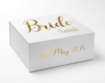 May include: White gift box with gold lettering that says "Bride Hannah 11th May 2018".