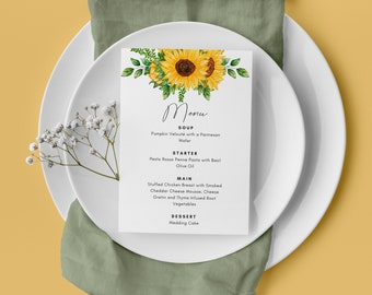 May include: A wedding menu with a sunflower floral design. The menu lists the following courses: Soup, Pumpkin Velouté with a Parmesan Wafer; Starter, Pesto Rosso Penne Pasta with Basil Olive Oil; Main, Stuffed Chicken Breast with Smoked Cheddar Cheese Mousse, Cheese Gratin and Thyme Infused Root Vegetables; Dessert, Wedding Cake.