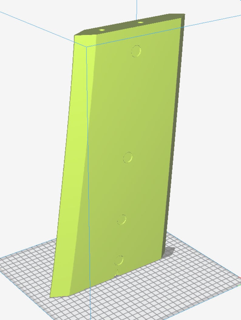 May include: A light green, rectangular object with a slanted edge and three circular indentations. Two small holes are at the top. The object is set against a grid background.